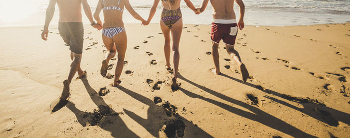 Happy friends enjoying on shore at beach