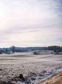 Scenic view of field against sky during winter