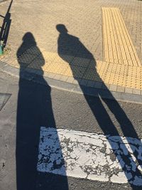 Shadow of people on road