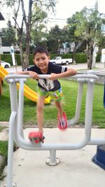 Portrait of happy boy playing in park