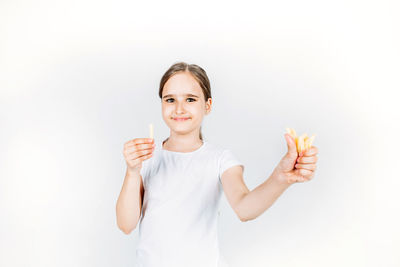 Portrait of smiling young woman against white background