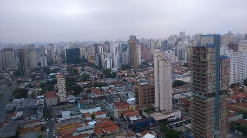 High angle view of buildings in city against sky