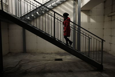 Side view of woman climbing stairs
