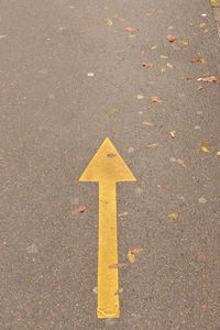 High angle view of arrow sign on road