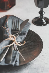 Close-up of cutlery and napkin in plate on table