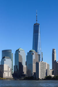 Modern buildings in city against blue sky