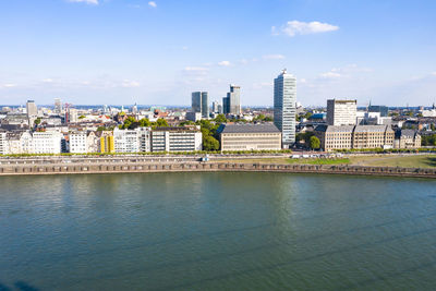 River and buildings against sky in city