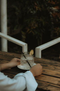 Close-up of hand holding lemon soda water