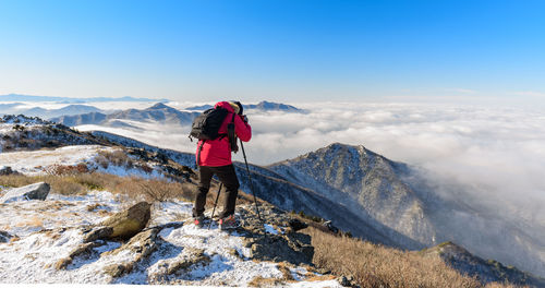 Woman standing on snow covered mountain