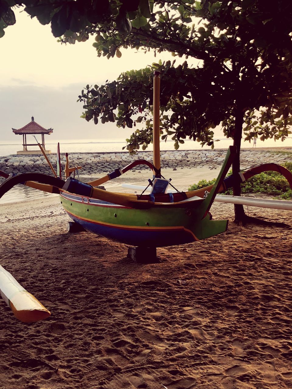 BOATS MOORED ON SHORE AGAINST SKY