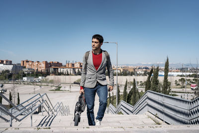 Full length of man standing on snow against clear sky