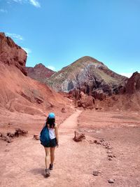 Rear view full length of young woman walking at valle de la luna