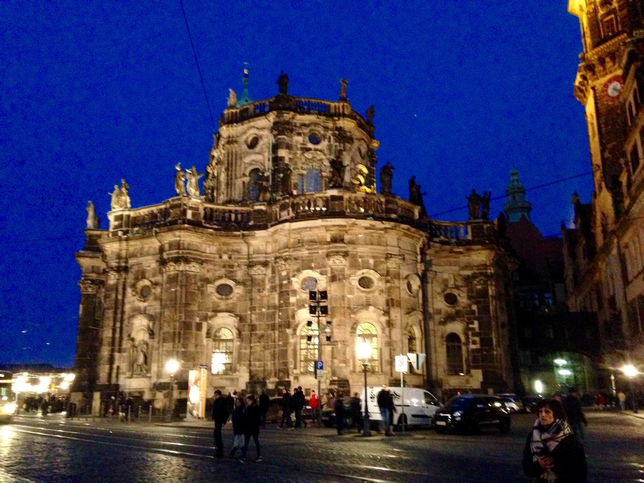 architecture, building exterior, built structure, large group of people, blue, place of worship, religion, church, men, person, famous place, clear sky, illuminated, street, spirituality, travel destinations, tourism, lifestyles