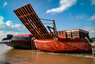 Ship moored on sea against sky