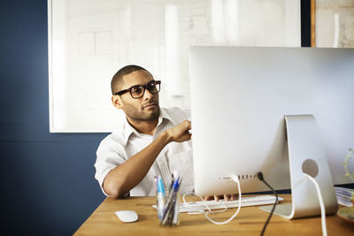 Man working on desktop computer in office