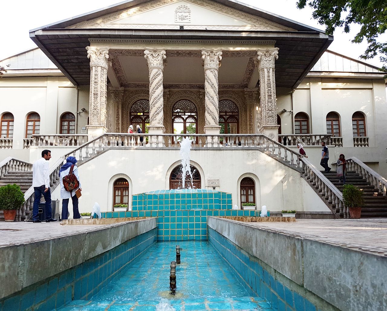 architecture, building exterior, built structure, steps, facade, city, staircase, famous place, stairs, outdoors, travel destinations, tourism, in front of, day, city life, stone material, person, architectural column, palace, history, architectural feature