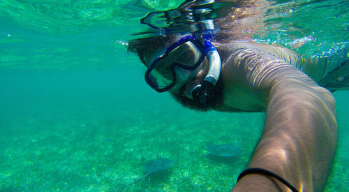 Close-up of man snorkeling in sea