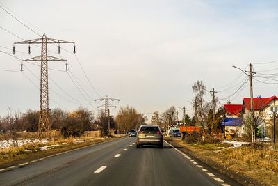 Cars on road against sky