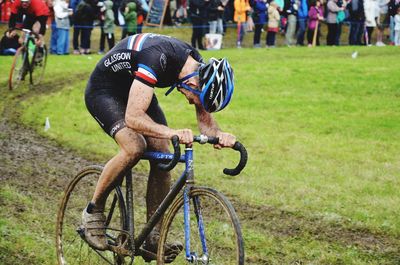 Man riding bicycle on grassland