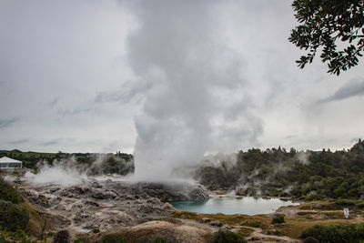 Scenic view of geyser against sky