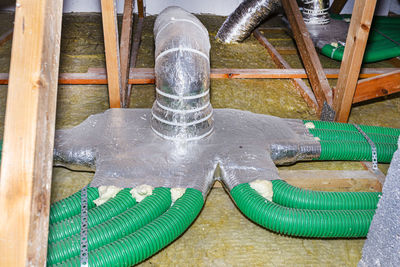 High angle view of water pipe on wood