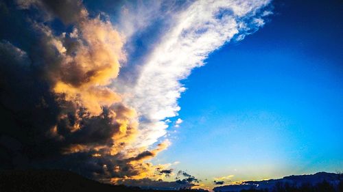 Scenic view of mountains against cloudy sky