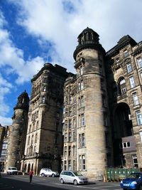 Low angle view of buildings against cloudy sky