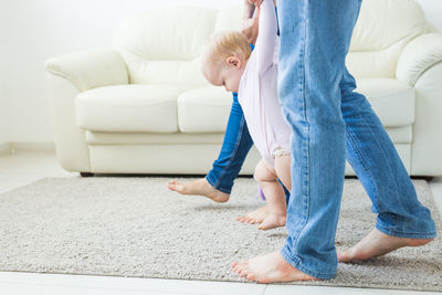 Parents playing with daughter at home