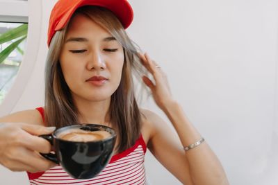 Portrait of young woman having drink