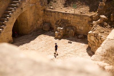 High angle view of woman standing by historic building
