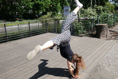 Full length shot of young woman doing cartwheel