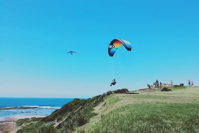 View of parachuting against calm sea