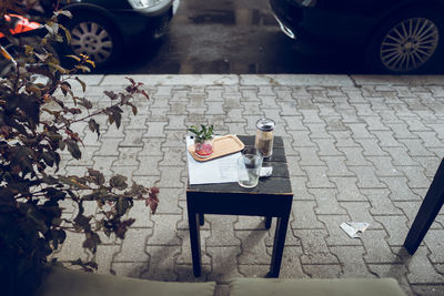 High angle view of chairs and table at sidewalk cafe