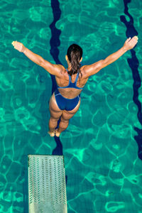 High angle view of swimmer diving into swimming pool