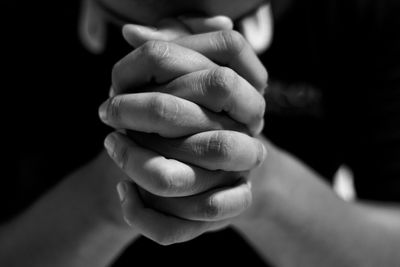 Depressed man close up hands is praying for hope and encouragement to continue living