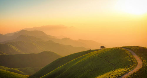 Scenic view of landscape against clear sky during sunset