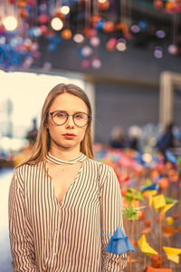 Young woman standing by craft products