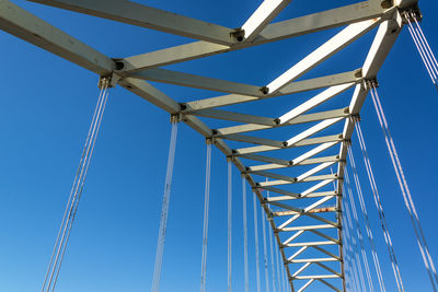 Low angle view of bridge against clear blue sky