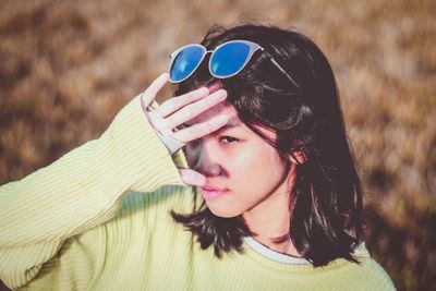 Young woman wearing sunglasses on field