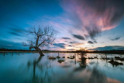 Scenic view of lake against sky during sunset