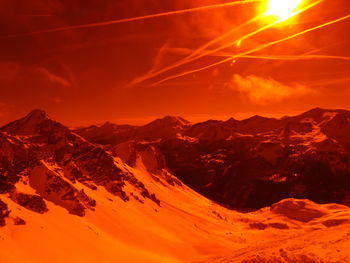 Scenic view of mountains against orange sky