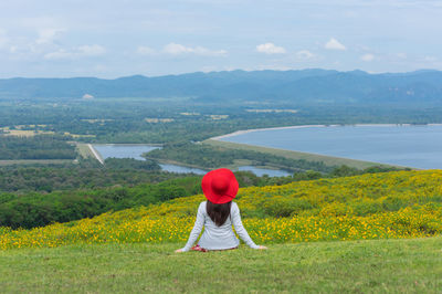 Rear view of man on field against mountains