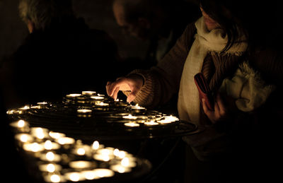 People lighting candles
