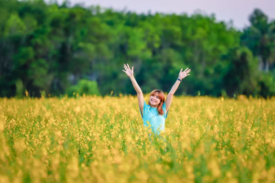 Rear view of woman standing on field