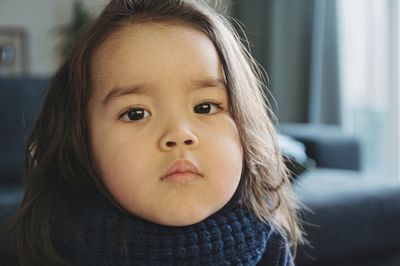 Close-up portrait of cute girl at home