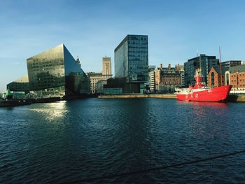 Boat in river against buildings