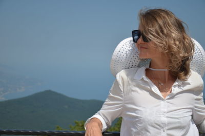 Rear view of woman against mountain range