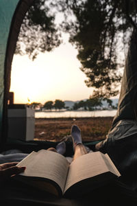 Low section of woman sitting on hammock