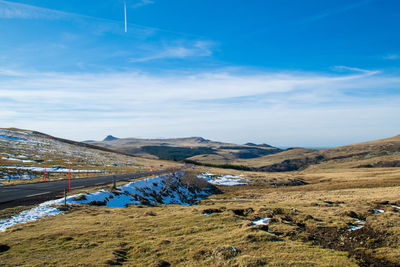 Scenic view of landscape against blue sky