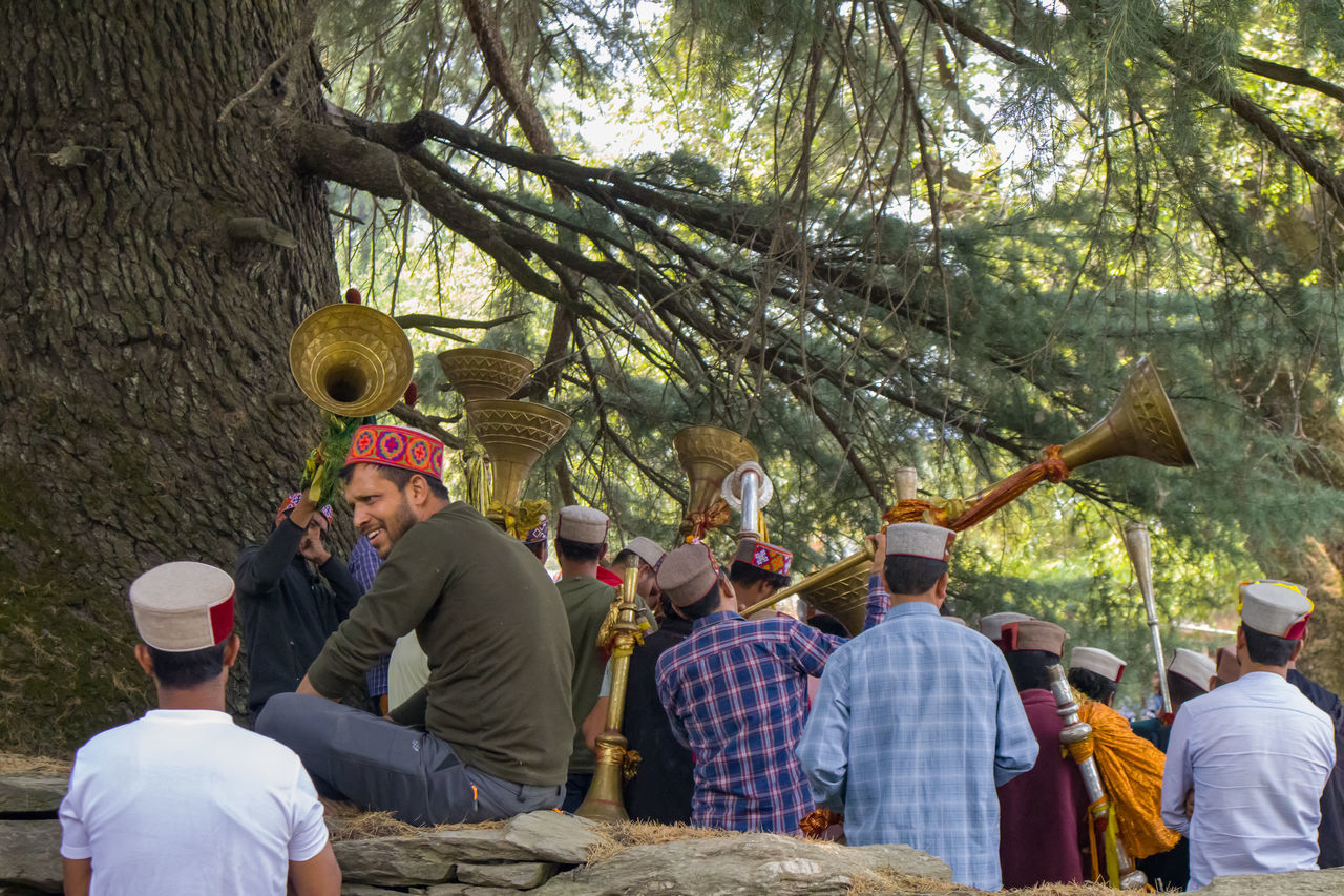 group of people, tree, men, adult, plant, crowd, nature, leisure activity, women, large group of people, day, lifestyles, celebration, togetherness, group, outdoors, rear view, clothing, tradition, person, event, enjoyment, forest, friendship